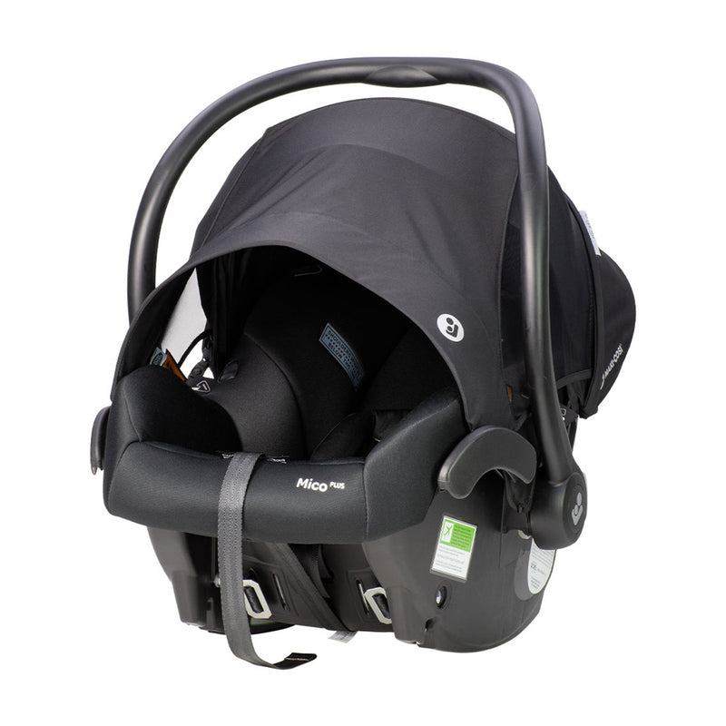 A black Maxi Cosi Mico Plus ISOFIX Baby Capsule with a curved handle, canopy, safety labels, buckles, and visible ISOFIX compatibility. The "Maxi Cosi" brand name appears on the side.