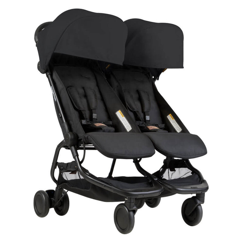 The Mountain Buggy Nano Duo Stroller is a lightweight black city stroller with two seats, canopies, harness straps, and an under-seat basket—ideal for comfortably transporting two children in style.
