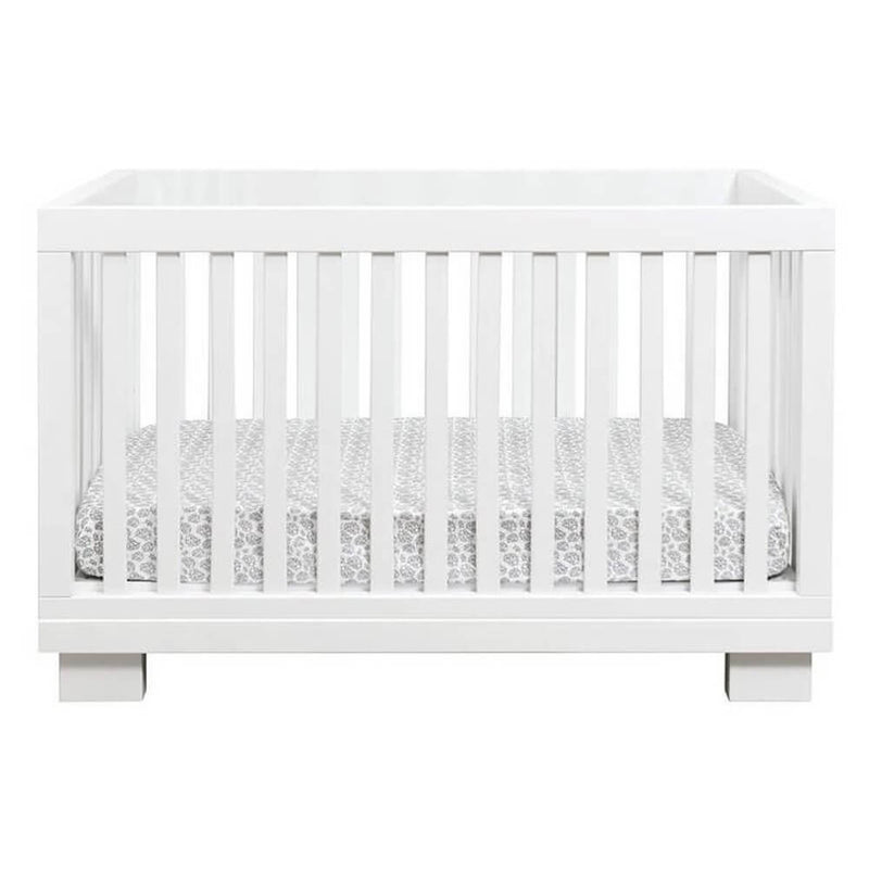 The Cocoon Aston Cot + Mattress by Cocoon, crafted from sustainable New Zealand pine with vertical slats and a grey-white patterned mattress, is shown on a plain white background. Includes toddler bed conversion for extended use.