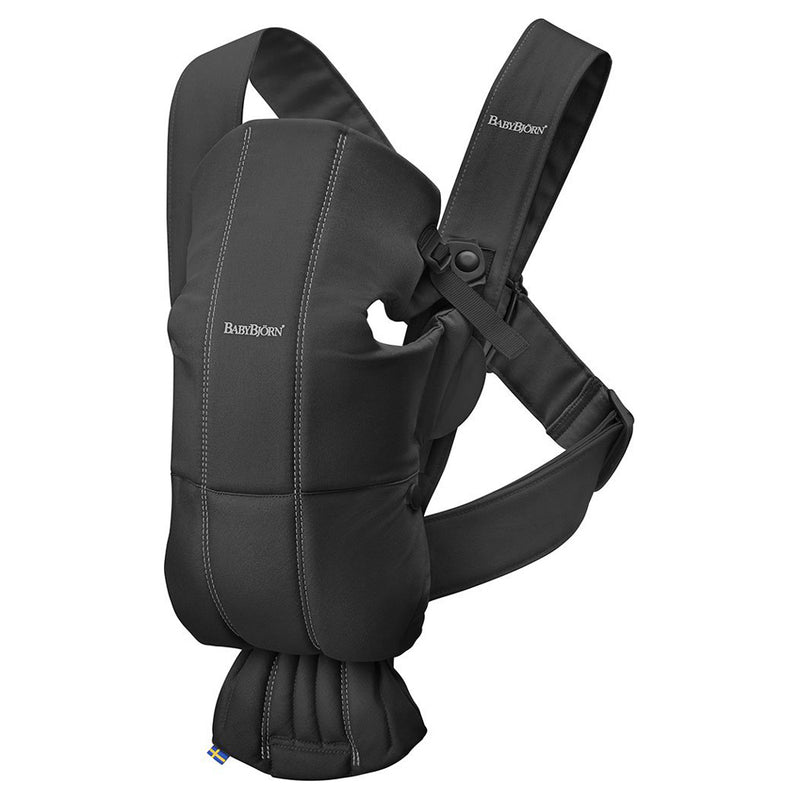 The BabyBjorn Carrier Mini Woven Black is a lightweight, cushioned baby carrier with adjustable shoulder straps for comfort, shown against a white background.