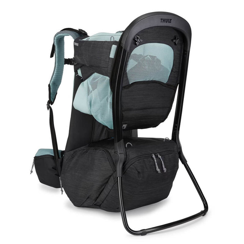 The Thule Sapling Child Carrier by Thule is a black and light blue backpack featuring a sturdy metal frame, padded shoulder straps, mesh ventilation, under leg support, and a spacious bottom zippered compartment for storage.