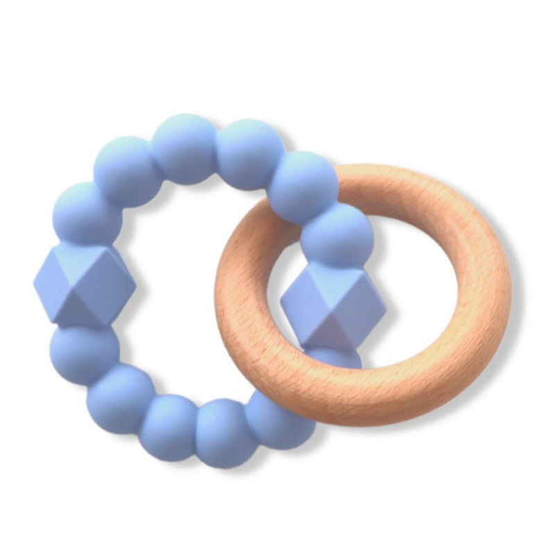 The Jellystone Moon Teether by Jellystone features a blue silicone beaded ring with two geometric beads, intertwined with a smooth, light beech wood teether. The background is white.