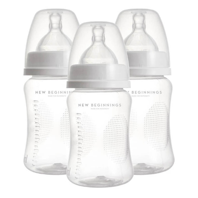 The New Beginnings PP Bottle 3Pk includes three BPA-free feeding bottles with white caps, silicone teats, side measurement markings, and dotted textures—arranged in a triangular formation. Bottles are branded "New Beginnings.