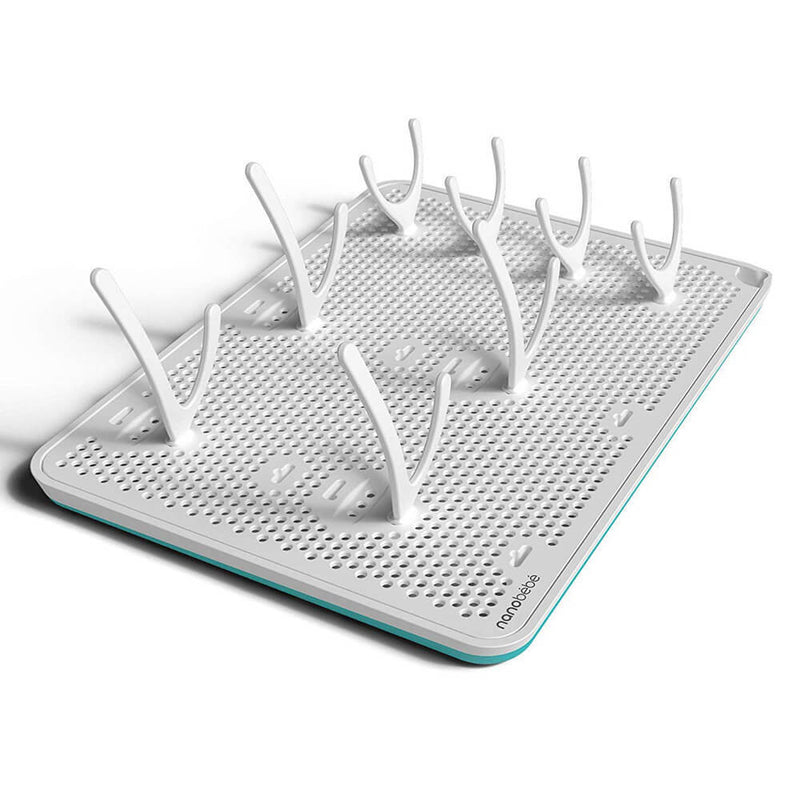 The Nanobebe Compact Drying Rack by Nanobebe is a slim, white rectangular rack with a turquoise edge and multiple curved pegs for upright storage, all on a perforated base for hygienic air circulation.