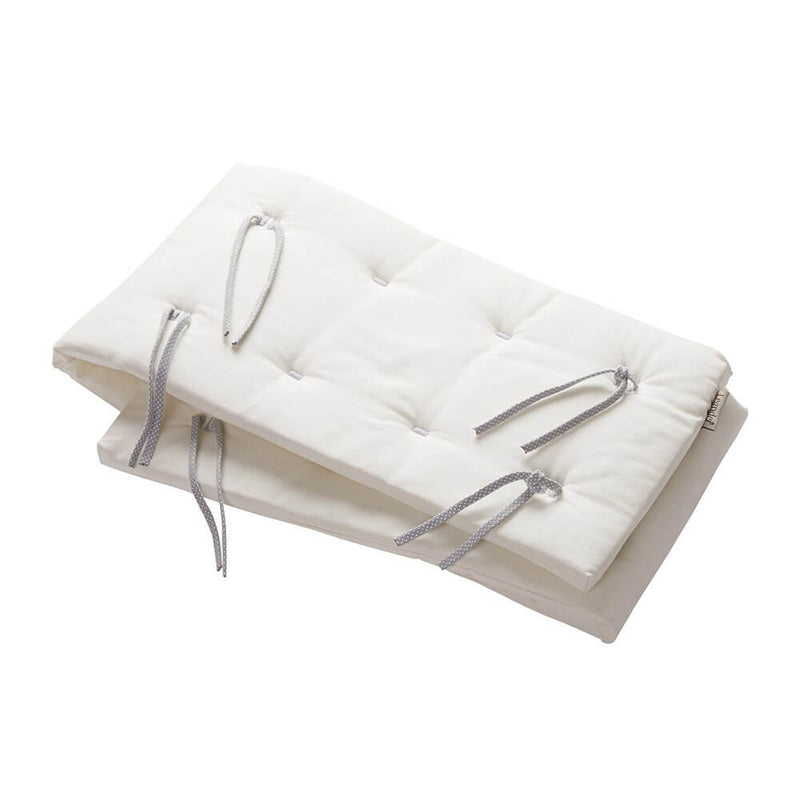 Two stacked white rectangular cushions with button tufting and gray ties, resembling the Leander Linea & Luna Organic Cot Bumper by Leander, are placed on a plain white background.