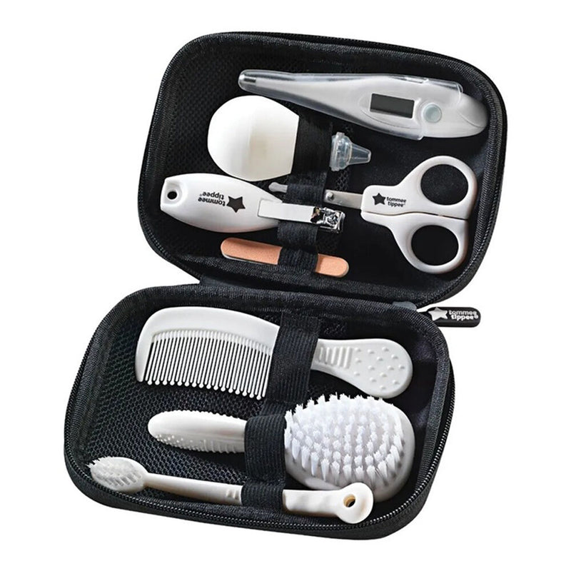 The Tommee Tippee Healthcare Kit by Tommee Tippee is a black zippered baby grooming set with essentials: digital thermometer, nasal aspirator, nail scissors, clippers, file, toothbrush, comb, and two brushes—all secured with elastic straps.