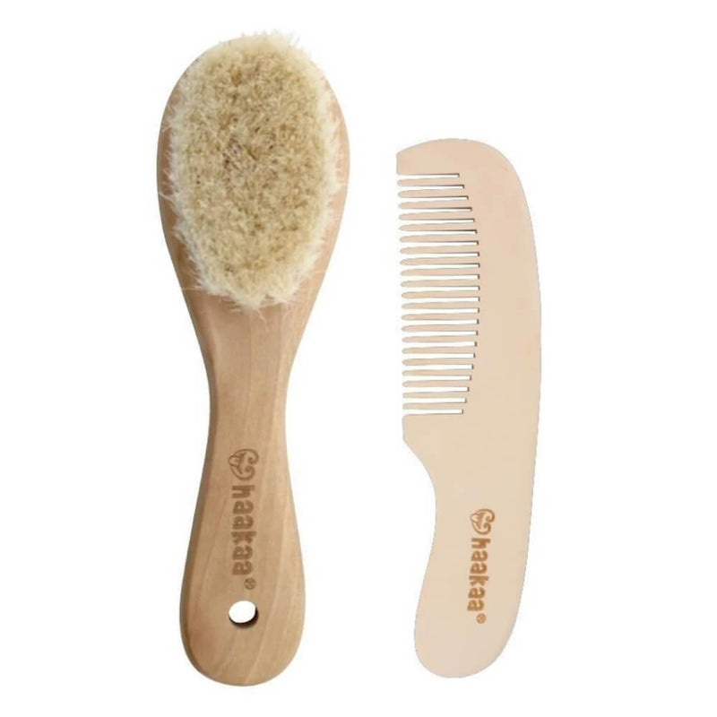 The Haakaa Goat Wool Baby Hair Brush & Comb Set features gentle goat wool bristles and a matching wooden comb, both branded with the Haakaa logo—ideal as a thoughtful baby shower gift.