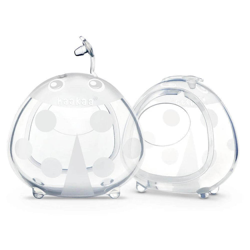 The Haakaa Silicone Milk Collector 75ml 2pk comes with two clear, dome-shaped storage cases with handles and dot patterns, perfect for holding and protecting your Haakaa collectors. Both open and closed cases are shown.