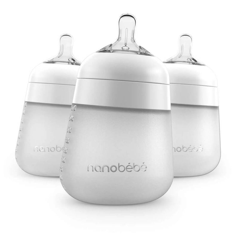 Three Nanobebe Flexy Silicone Bottles in white, each with clear nipples, are displayed. The modern, rounded design features measurement markings and helps ease your little one's breastfeeding transition. 3 pack by Nanobebe.