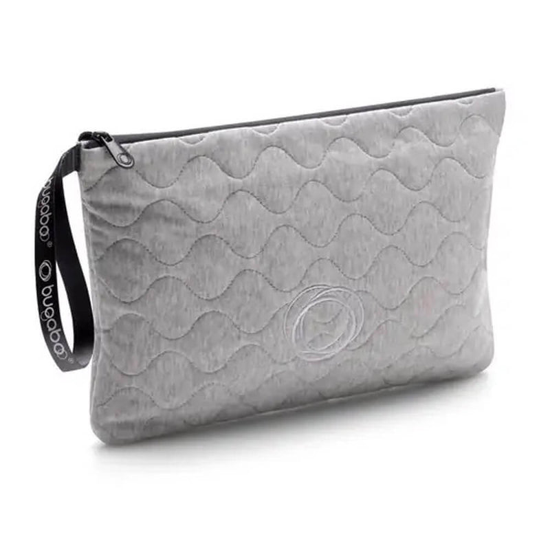 The Bugaboo Changing Clutch features a light gray quilted design with a wave pattern, black zipper and strap with white Bugaboo logo, and an embroidered circular detail—perfect as a portable changing mat for on-the-go use.