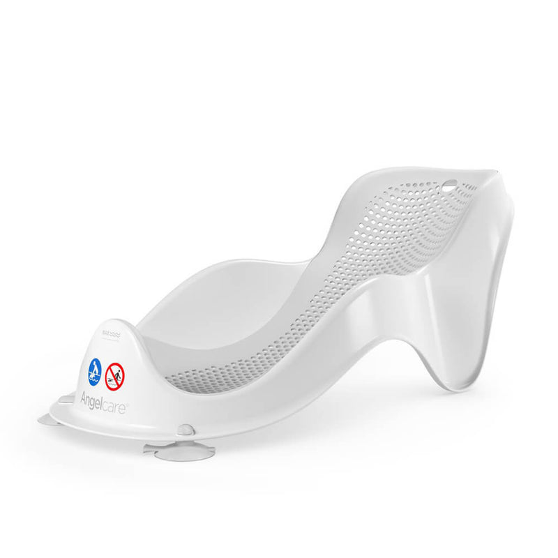 The Angelcare Baby Bath Support Fit is a white plastic ergonomic bath support for newborns, featuring a curved design, mesh seat, suction cups for stability, safety labels on the front panel, and "Angelcare" branding on the side.