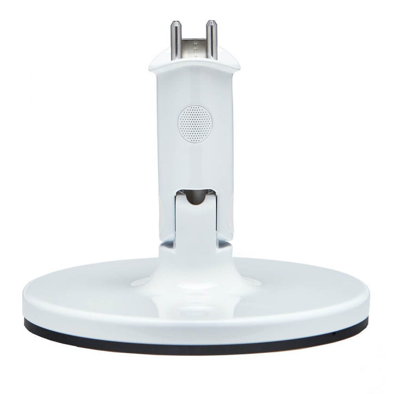 The Nanit White Multi Stand by Nanit is a tabletop base with a circular stand and upright attachment point, designed for the Nanit camera baby monitor. Viewed from the front, it features a power connector and a button or vent on its vertical section.