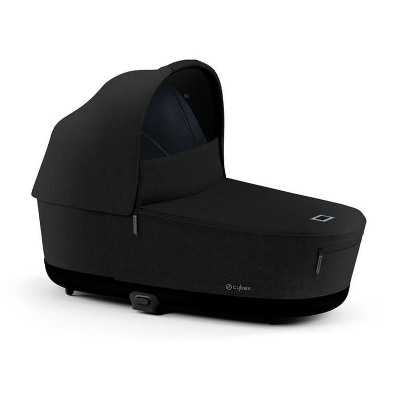 The Cybex Priam Lux Carry Cot by Cybex is a black baby bassinet with a canopy hood, modern design, subtle side logo, and breathable mattress—perfect for family travel. Shown on a white background.