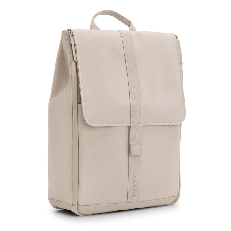The Bugaboo Changing Backpack by Bugaboo is a beige, rectangular stroller diaper bag featuring a top handle, front flap closure, clean lines, minimalist design, and a discreet logo near the bottom front.