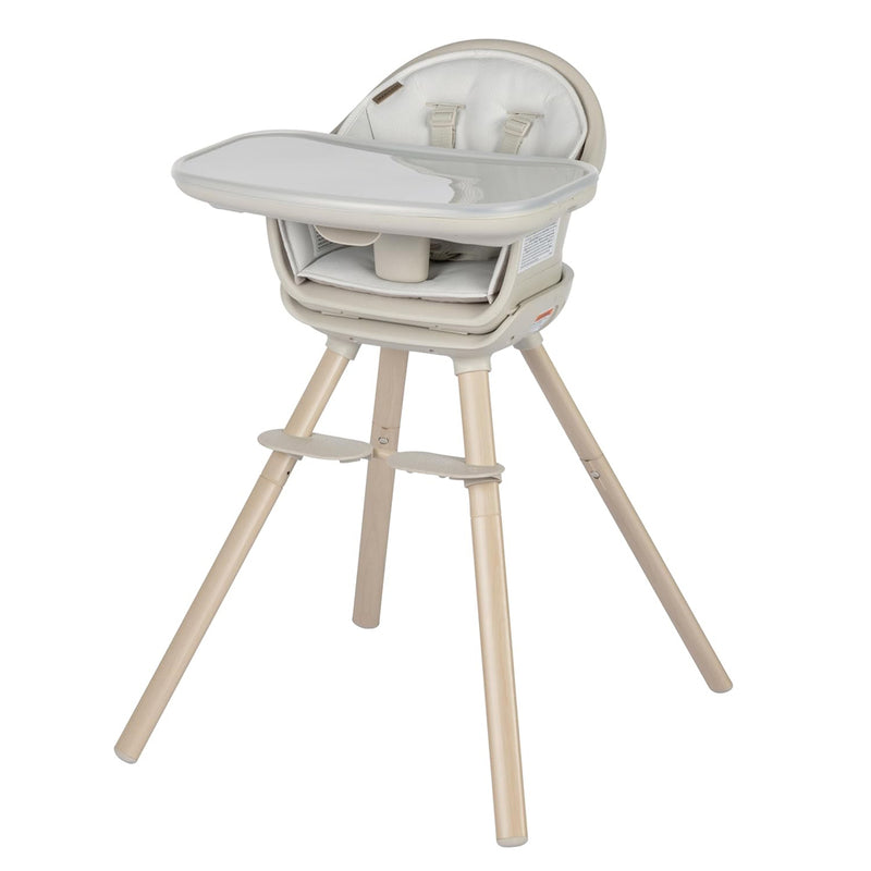 The Maxi Cosi Moa High Chair by Maxi Cosi is a modern 8-in-1 highchair with a beige seat, safety harness, light wooden legs, and detachable tray—perfect for feeding babies and toddlers at every stage.