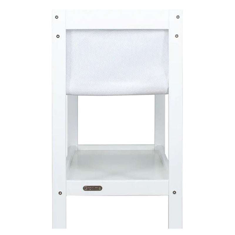 The Grotime Lilly Bassinet Stand, made from sustainable New Zealand timber, features a mesh storage pocket above and an open flat shelf below. Seen front-on, it’s a stylish base for your Grotime Lilly Bassinet baby sleep solution.