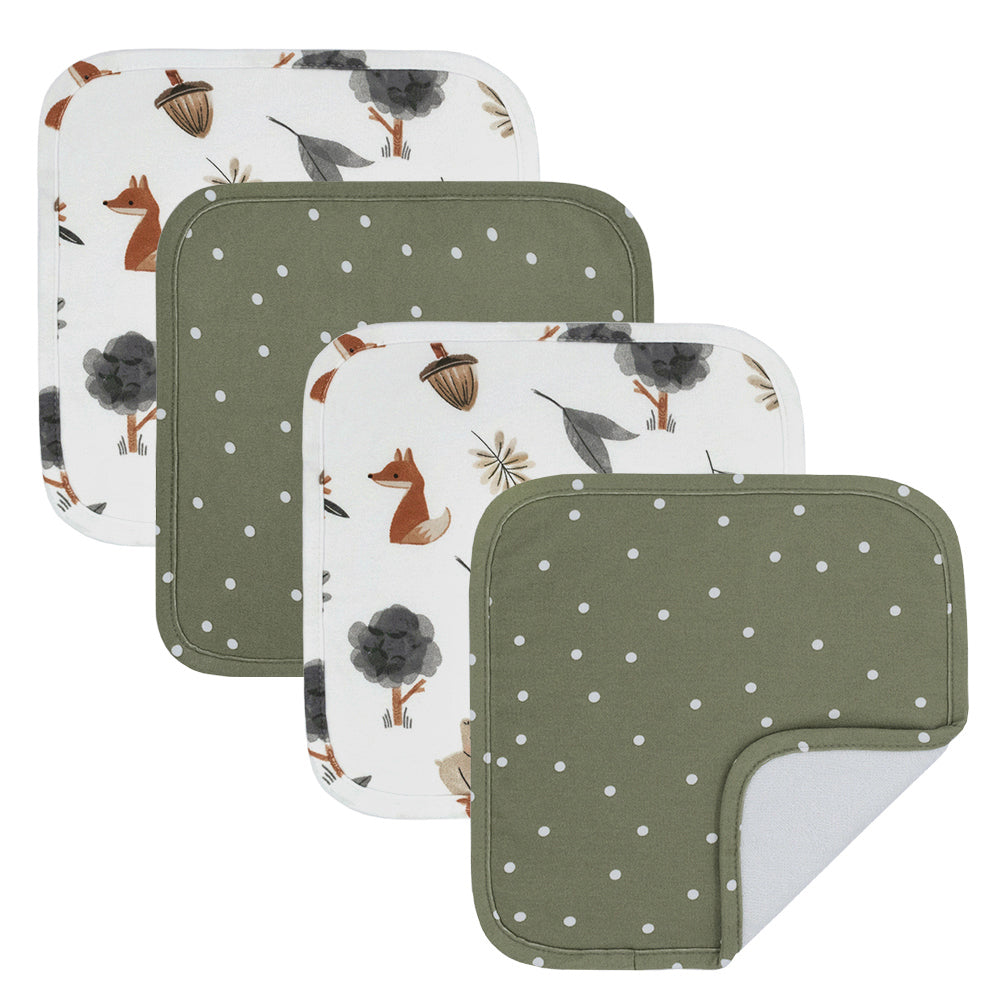 The Living Textiles Forest Retreat Wash Cloths 4pk are shown. Two feature olive green with white dots, and two display a woodland animal print. One gentle, soft wash cloth is flipped to reveal both absorbent sides.