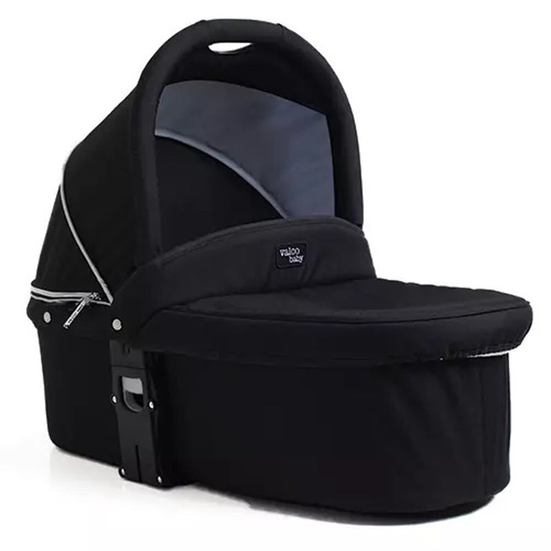 The Valco Baby Snap Ultra Duo Bassinet by Valco Baby is a black baby bassinet with an adjustable hood, curved canopy, zippered side, and the "Valco Baby" logo on the front.