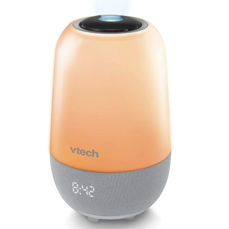 The VTech BC8313 V-Hush Pro Storytelling Soother is a peach and gray Bluetooth speaker with a digital clock, soft rounded edges, and a glowing blue night light projector on top.