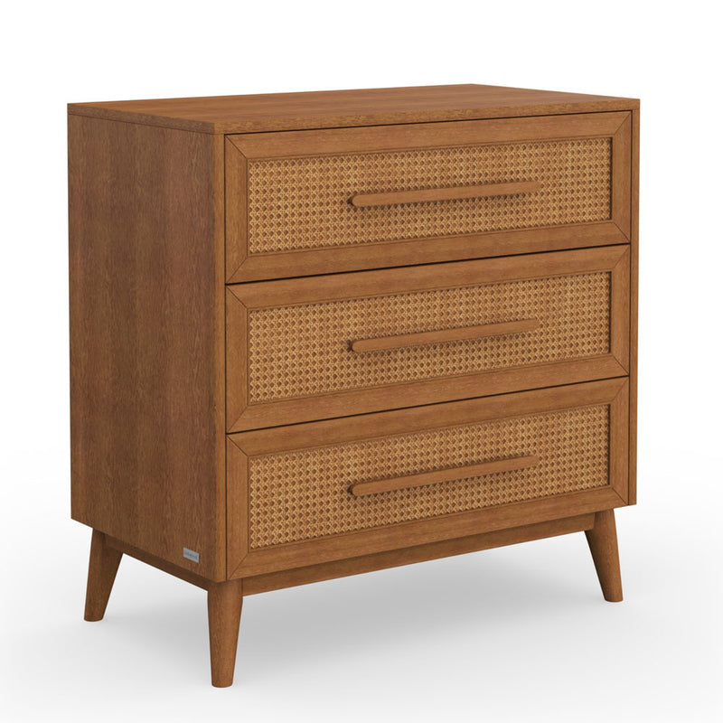 The BabyRest Kaya Chest 3 Drawer by BabyRest features three drawers with woven rattan fronts, long horizontal handles, and four angled legs—ideal for adding mid-century modern style to any nursery.