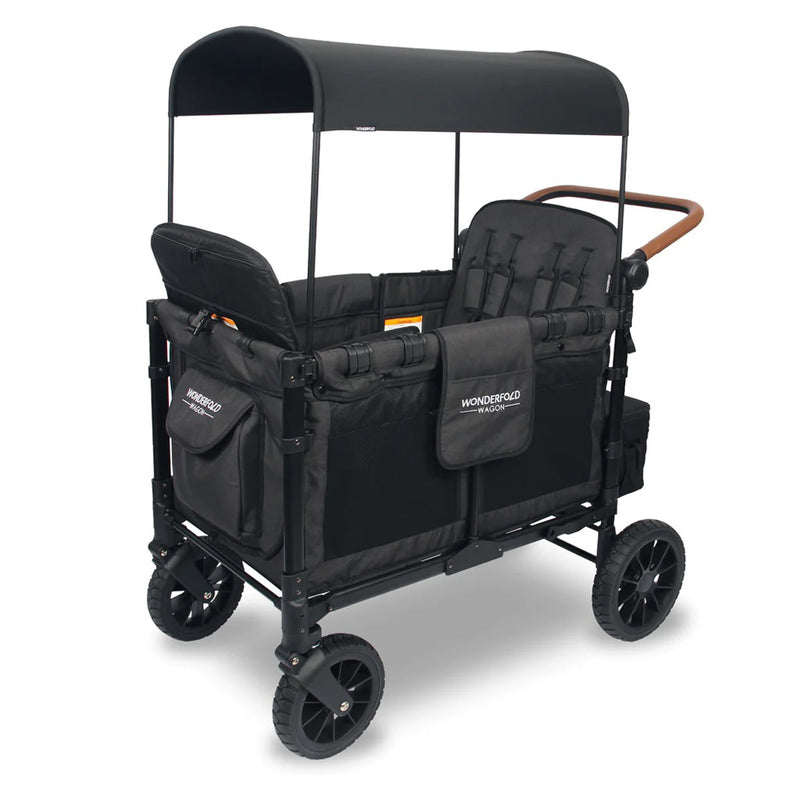 The Wonderfold W4 Luxe Quad Wagon by Wonderfold is black with a canopy, padded seats, storage pockets, four large wheels, a brown push handle, and features the Wonderfold logo on the side and front storage pouch.