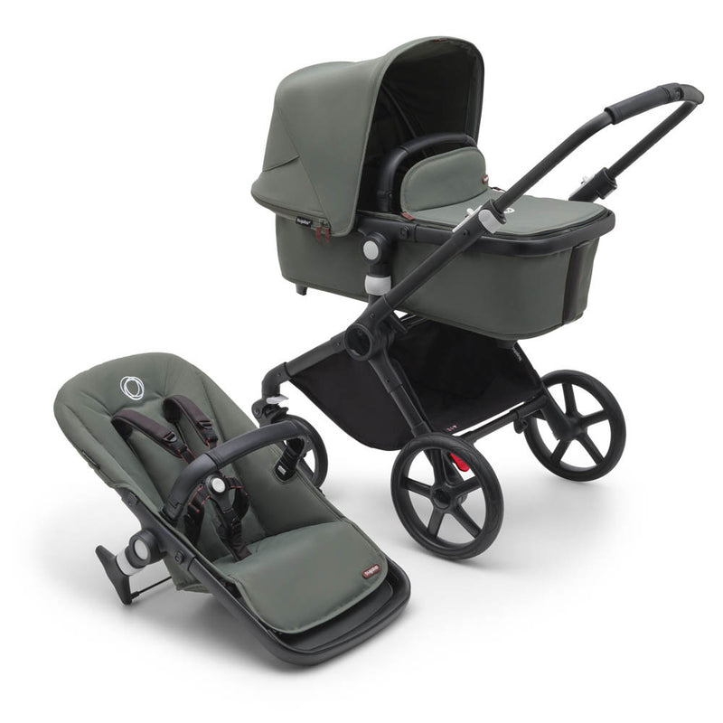 The Bugaboo Fox Cub Pram Complete by Bugaboo is a dark green, all-terrain stroller with a detachable bassinet, separate seat, sleek black frame, and large wheels—designed for compact use with infants or toddlers.