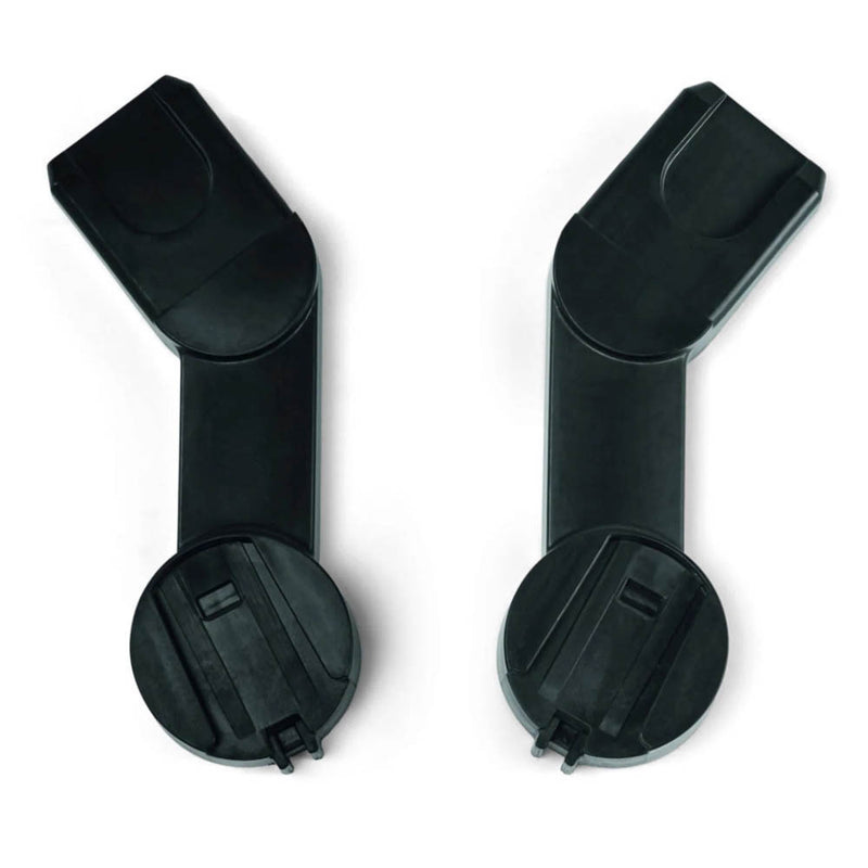 Two black plastic Mamas & Papas Strada Car Seat Adaptors, featuring rectangular and circular ends, are shown side by side on a white background—perfect for attaching your car seat to the Strada Pram travel system.