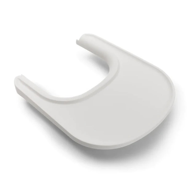 The Bugaboo Giraffe Tray by Bugaboo is a white plastic high chair accessory with a curved edge and raised sides, ideal for holding food or objects. It's dishwasher safe for easy cleaning.