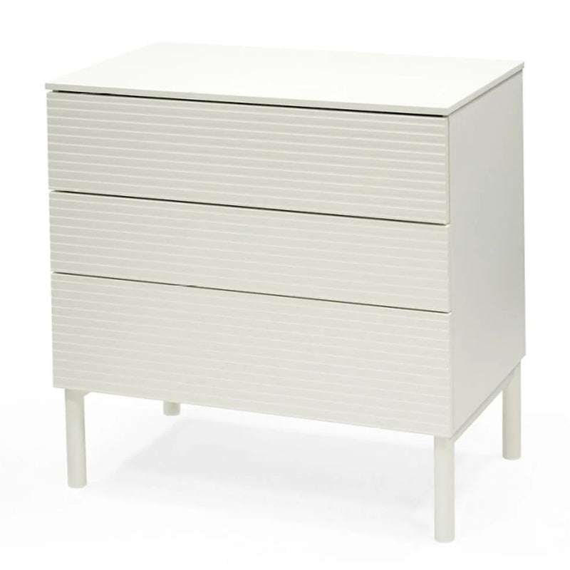 The Stokke Sleepi Dresser V3 White by Stokke is a modern, white dresser with three drawers, subtle horizontal lines, and short cylindrical legs—ideal as stylish nursery furniture with Scandinavian flair.