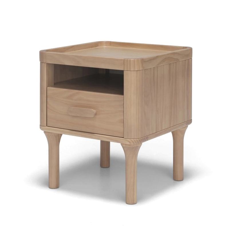 The Seena Willow Bedside Table by Seena is a wooden nightstand with rounded corners, an open shelf, and a rectangular-handled drawer. Made from sustainably sourced materials, it’s ideal for modern family spaces.