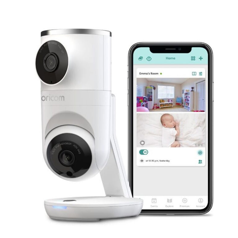 The Oricom Smart HD Dual Camera Baby Monitor by Oricom sits next to a smartphone showing a live video feed of a baby in a crib in a colorful nursery.