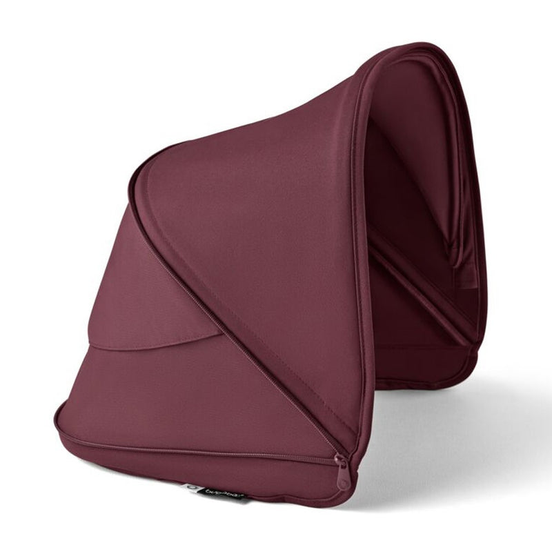 The Bugaboo Dragonfly Sun Canopy by Bugaboo is displayed upright on a white background, showing its maroon color, structured design, seams, zipper details, and UPF 50+ sun protection.