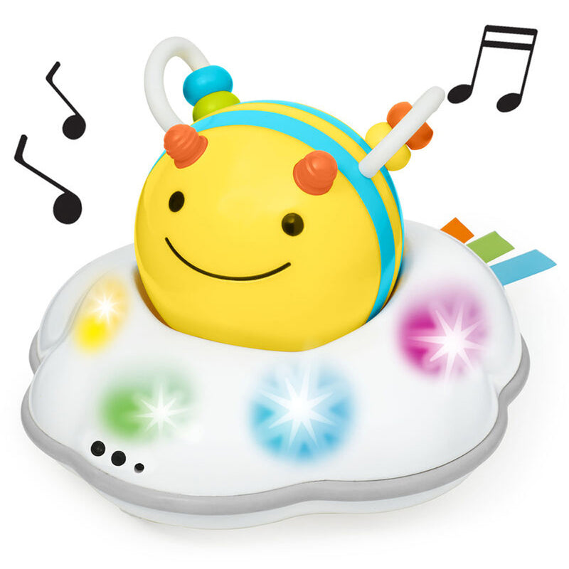 The Skip Hop Explore & More Follow Bee Crawl Toy features a cheerful yellow bee with antennae on a white cloud base, colorful lights, and music, making it a fun way to encourage motor skill development for babies.