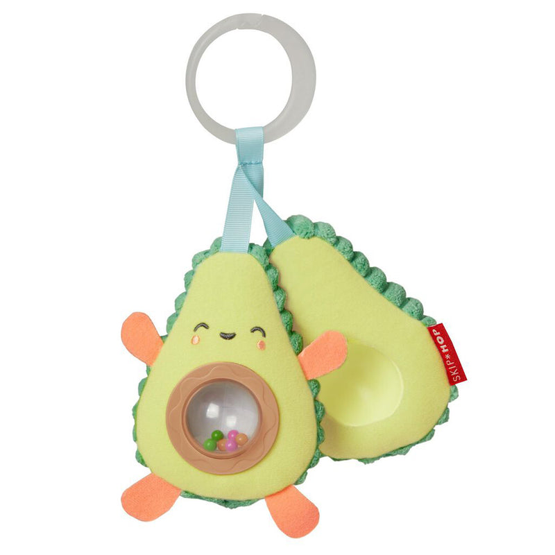 The Skip Hop Farmstand Avocado Stroller Toy is a soft, avocado-shaped plush with a smiling face, orange arms and legs, a clear rattle with colorful beads, and a plastic ring for easy hanging—ideal for strollers or play at home.