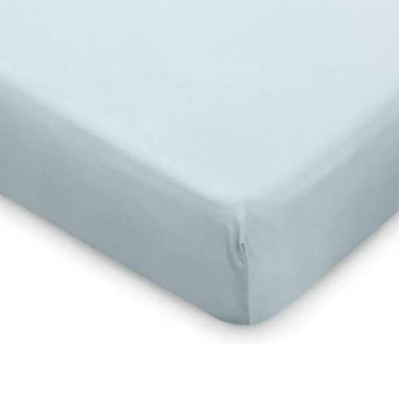 A close-up of a bed corner featuring the Boori Universal Jersey Cotton Cot Fitted Sheet in light blue, tightly covering the mattress.