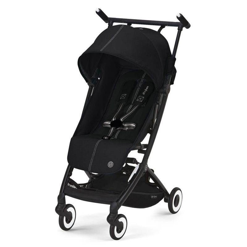 The Cybex Libelle Stroller by Cybex is a modern black compact travel stroller with white accents, a canopy, five-point harness, four wheels, and an under-seat storage basket. This lightweight buggy is shown empty against a white background.