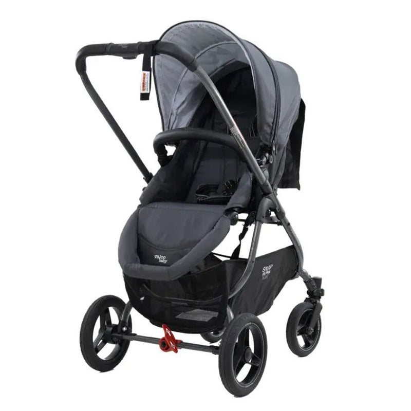 A Valco Baby Snap Ultra Elite stroller in gray and black, featuring a reversible padded seat, canopy, three large wheels, and a storage basket underneath, displayed on a white background.
