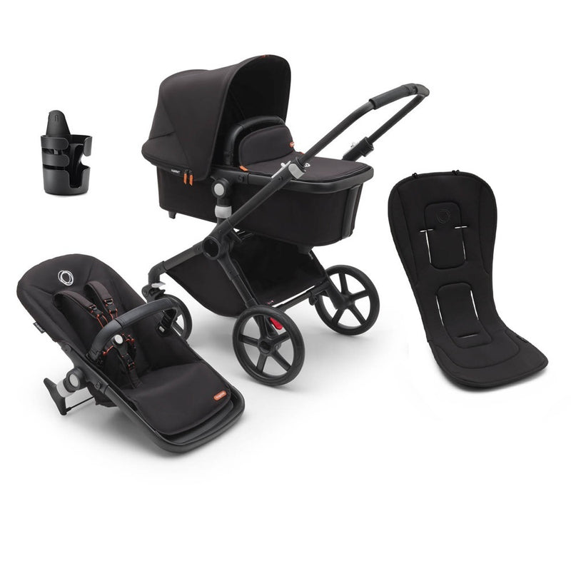 A black Bugaboo Fox Cub bundle featuring the all-terrain stroller, cup holder, dual seat liner, bassinet, separate stroller seat, and infant car seat adapter by Bugaboo—all shown on a white background.