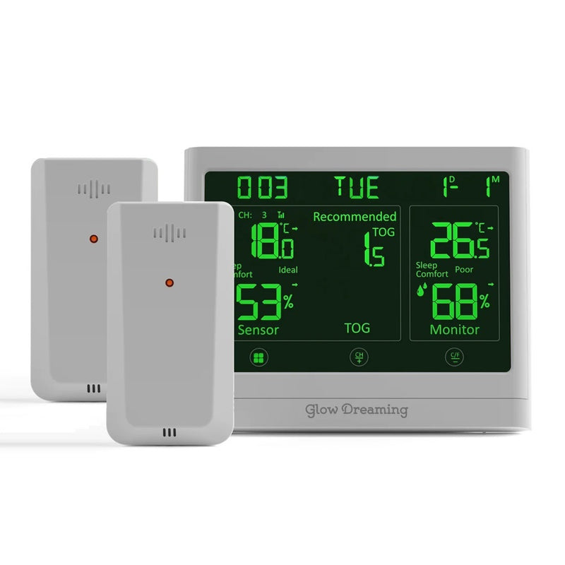The Glow Dreaming Sleep Sensor Bundle includes a green-display monitor showing temperature, humidity, and comfort levels, plus two white rectangular sleep sensors to help monitor your child's sleep conditions.
