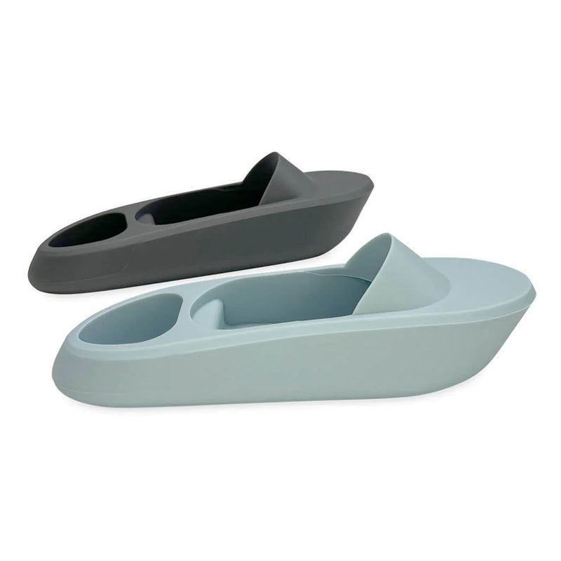 The Cherub Baby Silicone Bath Toy Boats Ocean Storm set includes one gray and one light blue boat, each with a front cup and middle slot. Dishwasher safe, these baby bath toys from Cherub Baby are shown on a white background.