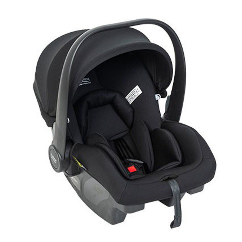 The Britax Safe-n-Sound B-Pod Lite Baby Capsule is a black infant car seat with a carrying handle, padded interior, harness, and label tags. Designed for safety and comfort, it's travel system compatible for easy vehicle transport.