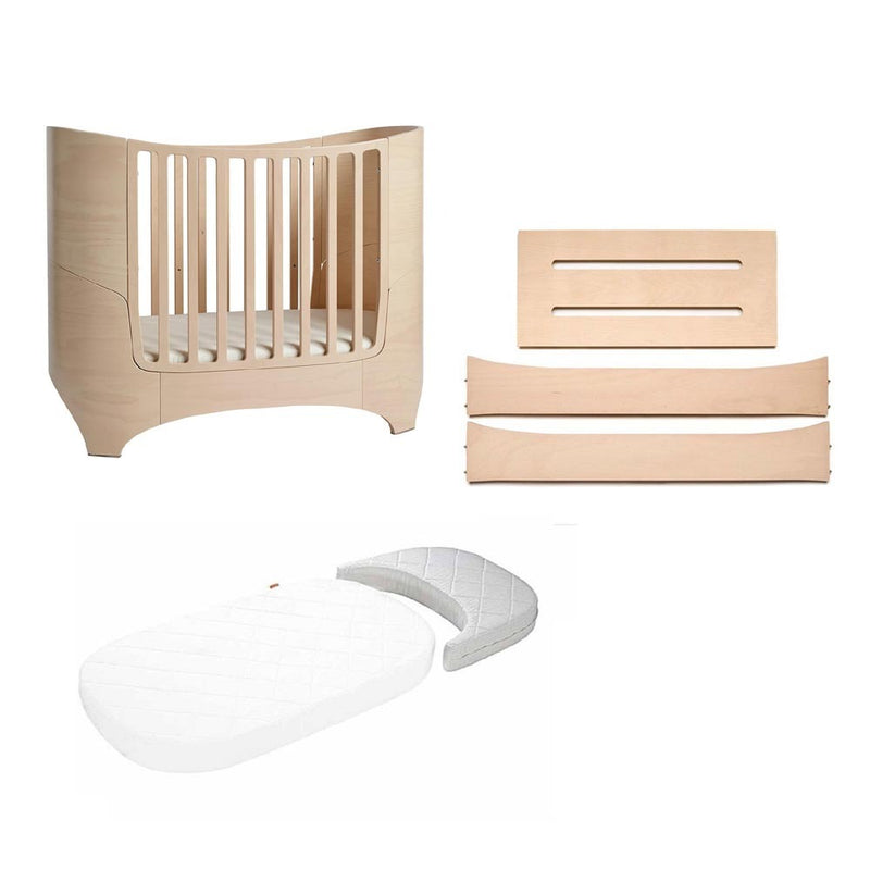 The Leander Classic Cot + Junior Bed Extension Bundle by Leander features a modern light wood cot with matching panels and includes a white quilted crib mattress—ideal for those who love the iconic Leander Classic Cot style.