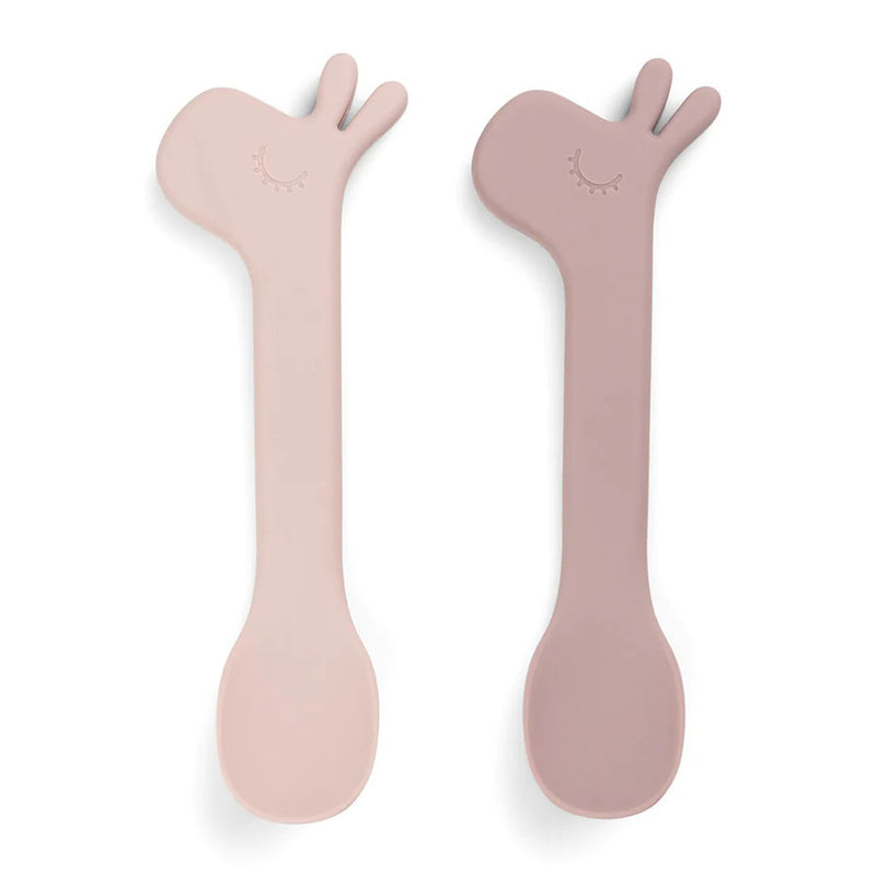 The Done By Deer Silicone Spoon 2-Pack Lalee Powder features two pastel silicone giraffe-head spoons with cute detailing, perfect for toddlers learning self-feeding.