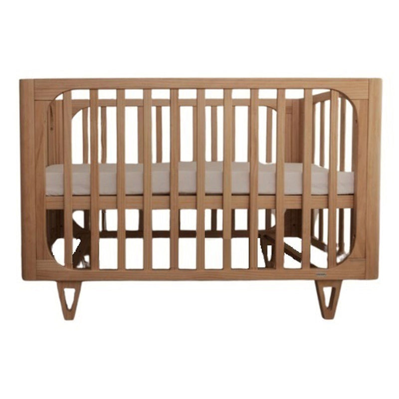 The Cocoon Vibe 4 In 1 Cot + Mattress Sandstone by Cocoon features sustainably sourced pine wood, vertical slats, angled legs, and a white mattress, shown against a plain white background.