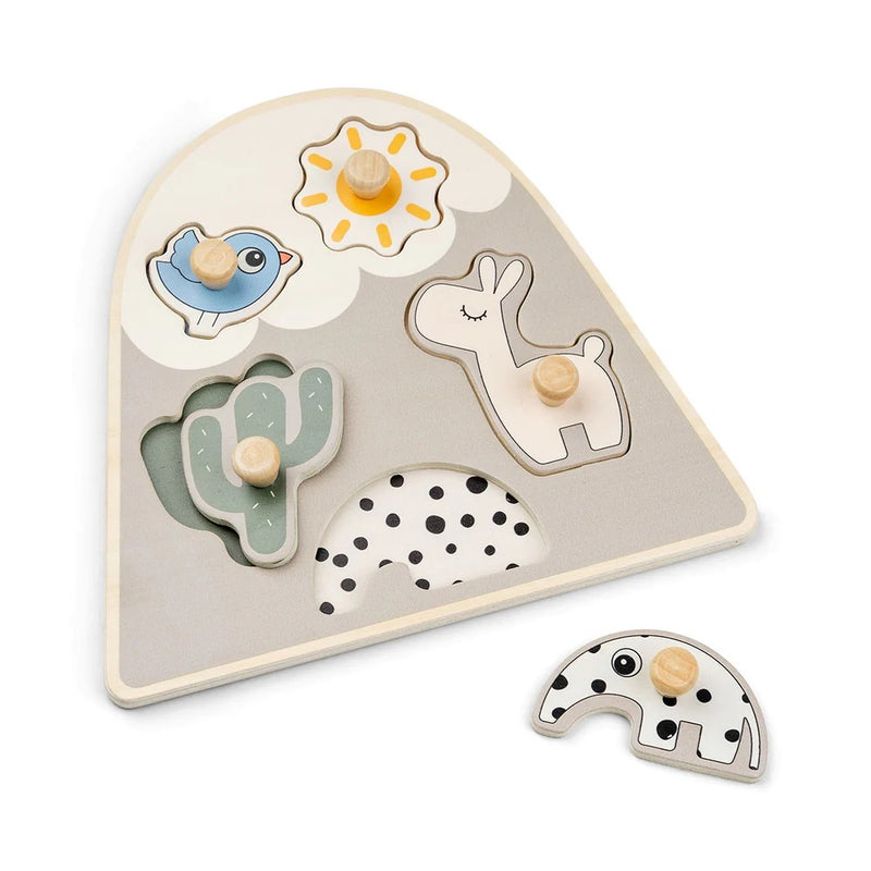 The Done By Deer Peg Puzzle Lalee Sand by Done By Deer is a toddler puzzle with four wooden pieces: sun, blue bird, green cactus, and white llama, plus a polka-dotted arch—perfect for fine motor skill development.
