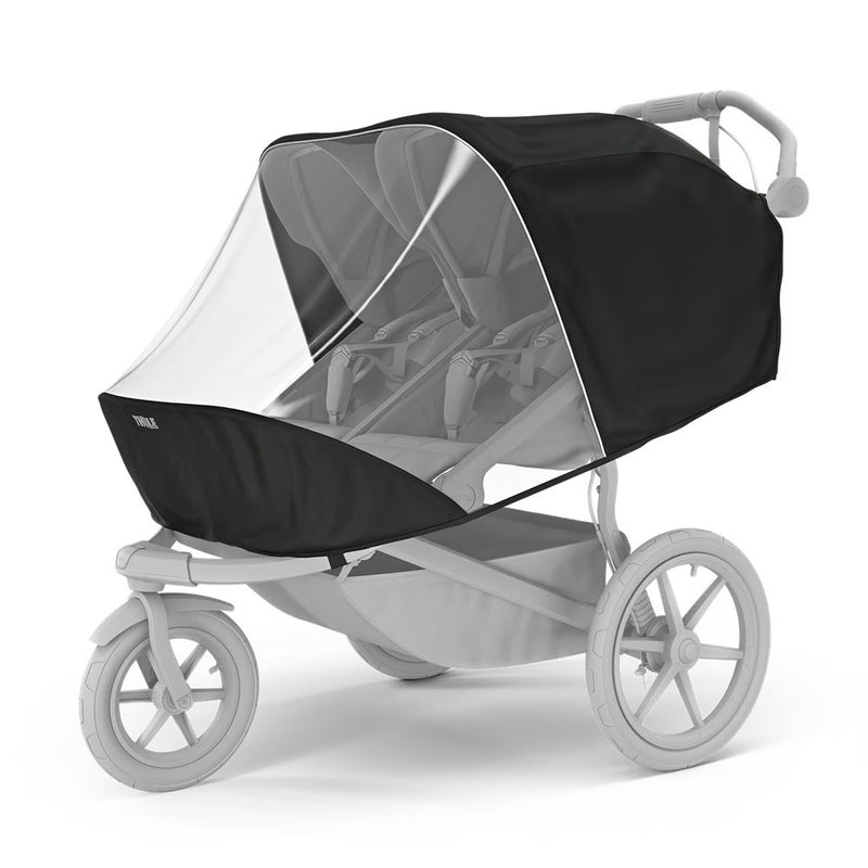 The Thule Urban Glide 3 Double Rain Cover by Thule is shown installed on a double jogging stroller, offering black and white mesh weather protection for both seats and attaching securely to the frame in a grayscale setting.