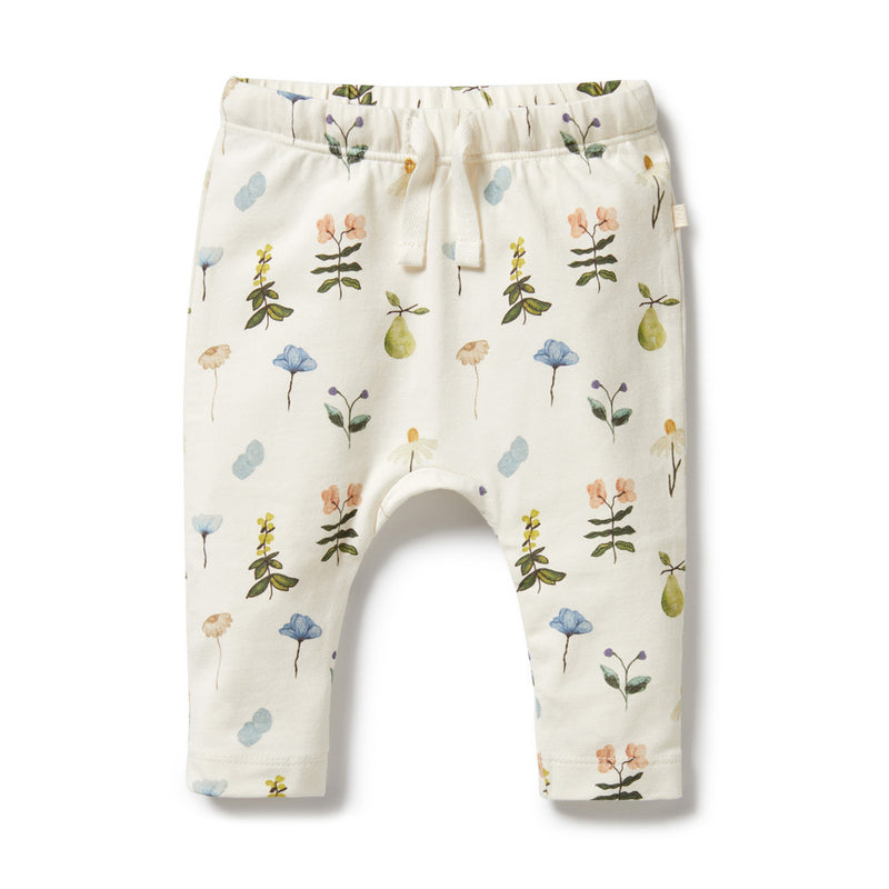 Wilson & Frenchy Petit Garden Organic Legging: cream leggings made from organic cotton, featuring an elastic waistband, drawstring, and a delicate print of flowers, green pears, and pastel leaves.