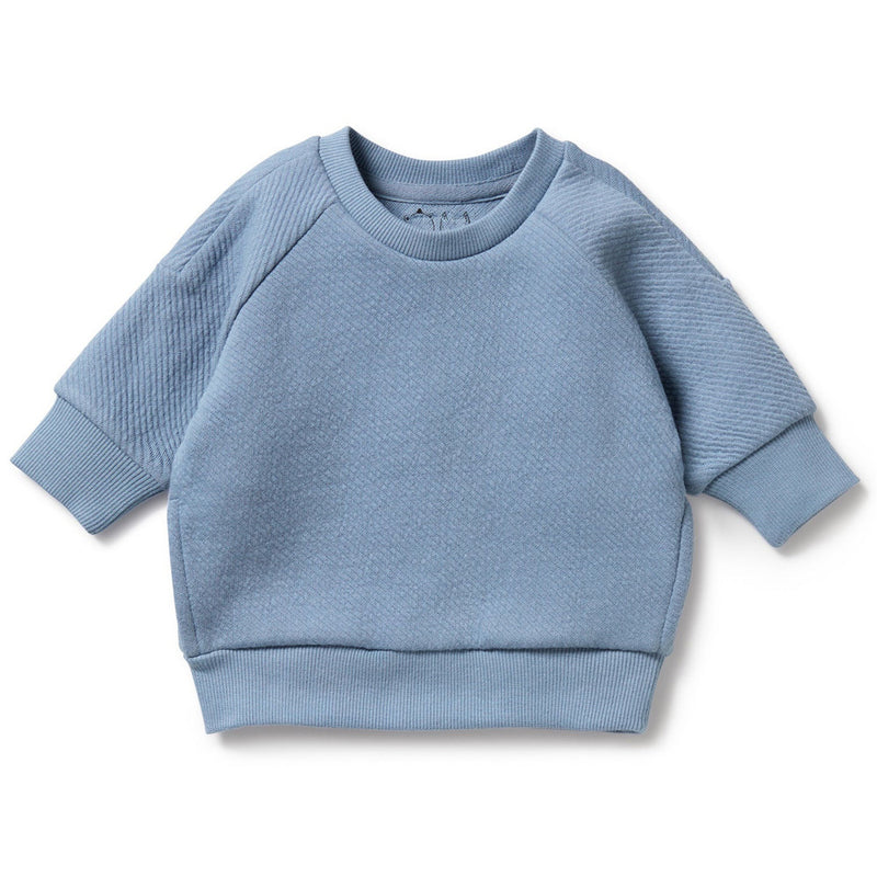 The Wilson & Frenchy Storm Blue Organic Quilted Sweat is a cozy baby sweatshirt with ribbed cuffs, crew neck, and waistband—ideal winterwear for babies. Displayed on a white background.