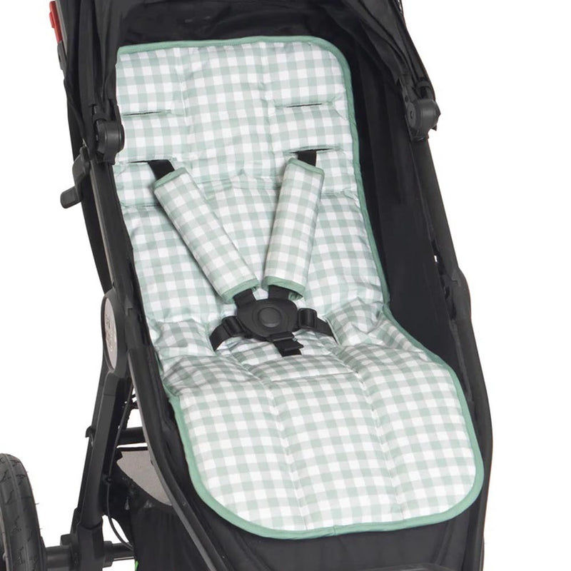 A close-up of the All4Ella Pram Liner Gingham Sage by All4Ella, a light green and white gingham padded liner with harness straps on a black stroller—an essential baby pram accessory for comfort and style.