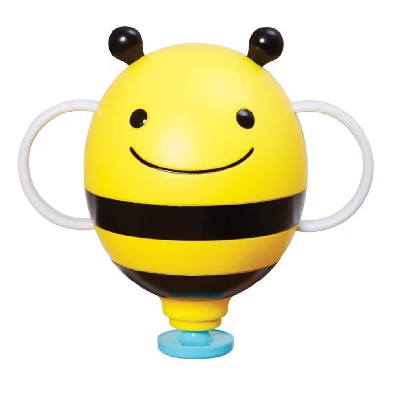 The Skip Hop Zoo Bath Fill Up Fountain Bee, a yellow bee-shaped bath toy with black stripes, a smiling face, two antennae, and white side handles, stands on a blue base against a white background.